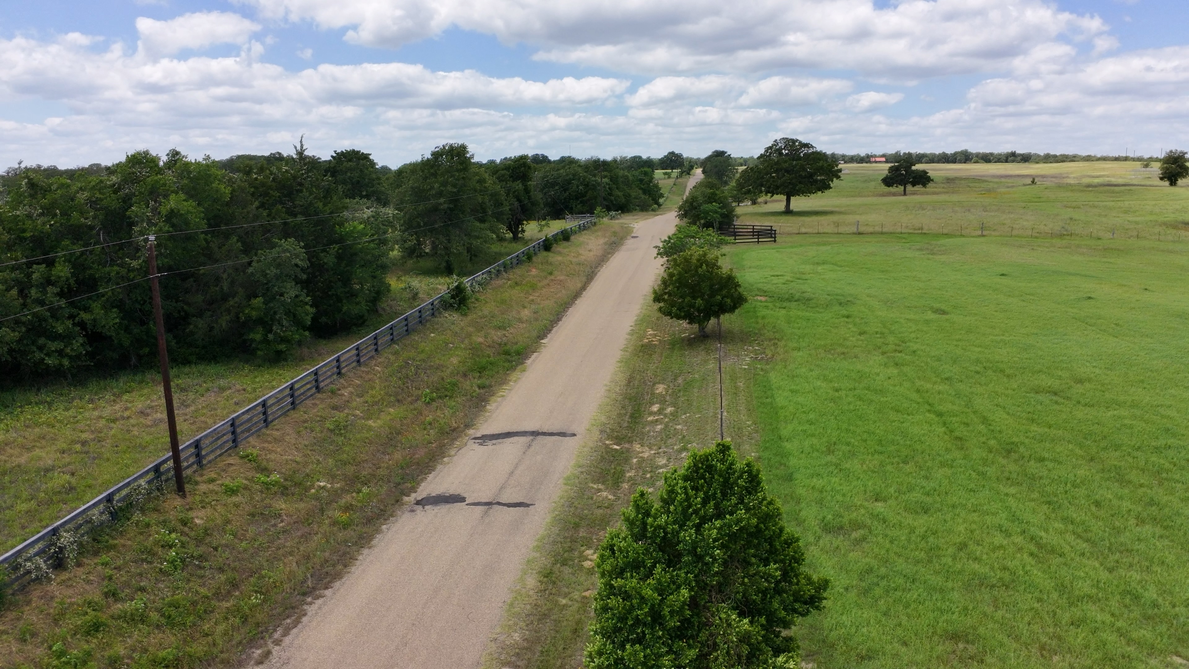 Aerial view of paved County Road 238 frontage